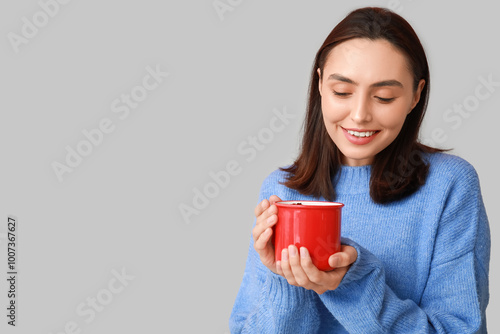 Smiling young woman holding...