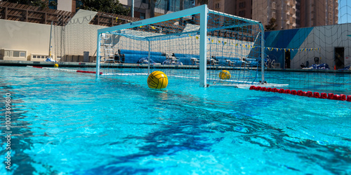 Schilderij op canvas Yellow Water Polo Ball in Focus Floating in on the Goal Line of a Cage