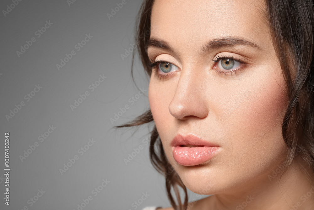Young woman with beautiful lips against grey background, closeup Young woman with beautiful lips against grey background, closeup