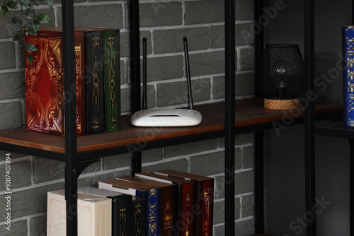 Modern wi-fi router on book...