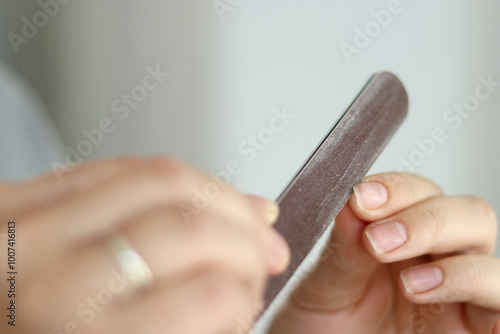 Close up of woman doing her nails at home, natural manicure  photo