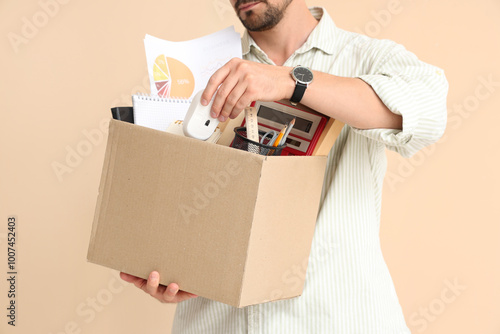 Fired young man packing his...