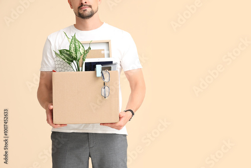 Fired young man holding box...