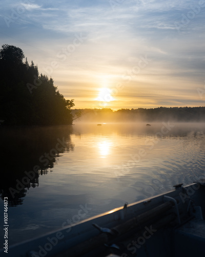 sunrise on boat in lake
