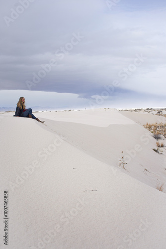 girl sitting on white sand dune