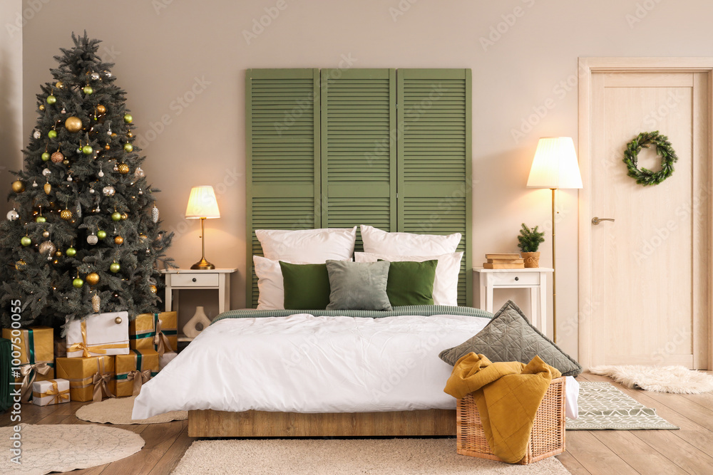 Fototapeta premium Interior of bedroom with door, Christmas tree and glowing lamps