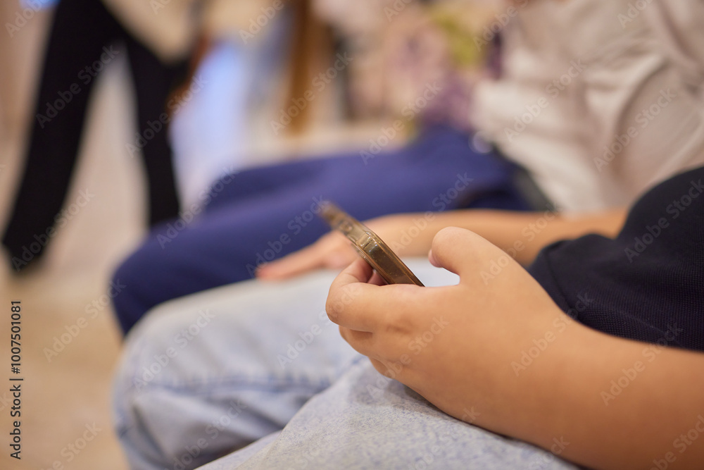 In the waiting area, children are actively engaging with various technology devices In the waiting area, children are actively engaging with various technology devices