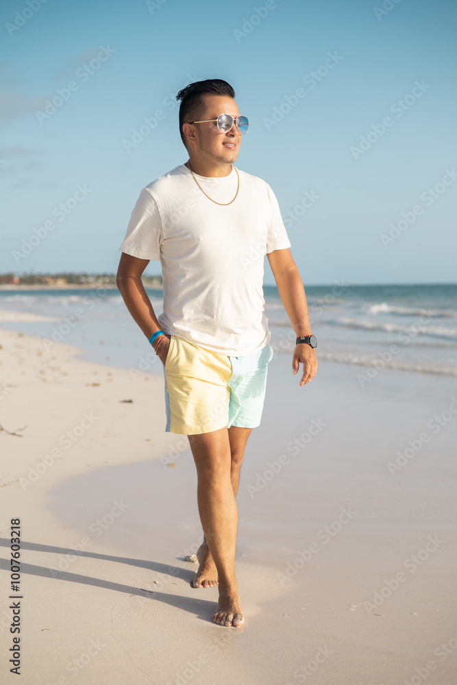 enjoying vacation, young latin man in light clothes and sunglasses on a sunny day walking on the beach, relaxed lifestyle, men's fashion enjoying vacation, young latin man in light clothes and sunglasses on a sunny day walking on the beach, relaxed lifestyle, men's fashion