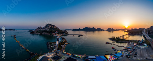 Seonyudo Island, Gunsan-si, Jeollabuk-do, South Korea - April 27, 2020: Aerial view of Daejangdo Island and Jangjado Bridge at a small fishing village at sunrise photo