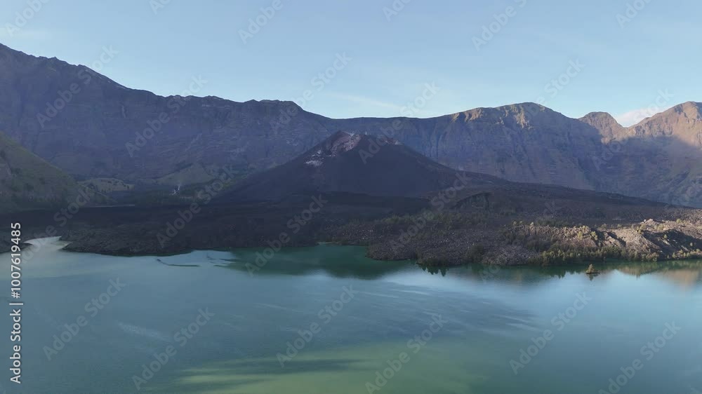 The exoticism of a lake with a volcano in the middle, high cliffs surrounding it and warm sunlight The exoticism of a lake with a volcano in the middle, high cliffs surrounding it and warm sunlight
