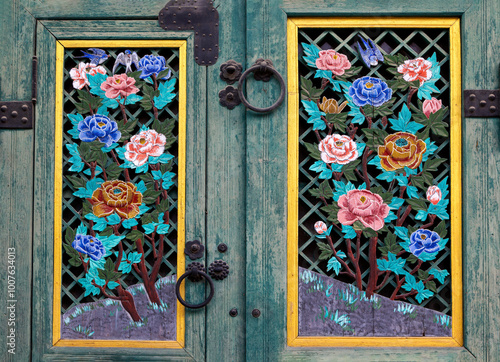 Wooden door with flower patterns at Changdeokgung Palace near Jongno-gu, Seoul, South Korea photo