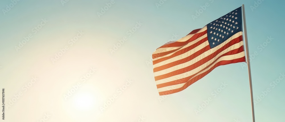 Obraz premium American Flag Waving Against Bright Sunlight and Clear Sky