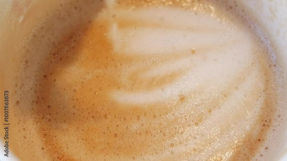 sugar pouring from a in a paper packet on a coffee cup sugar pouring from a in a paper packet on a coffee cup