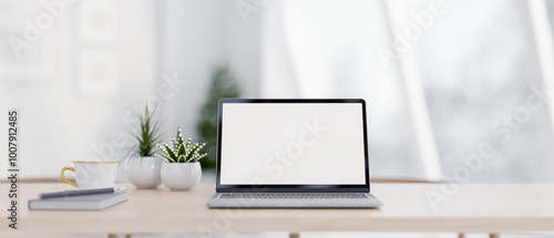 Wallpaper Mural A close-up of a laptop with a white screen mockup on a wooden table in a bright room. Torontodigital.ca