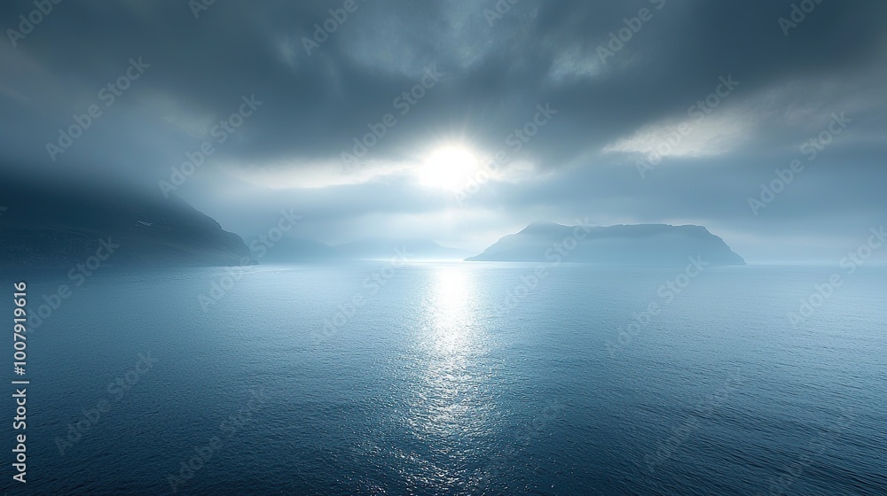 Dramatic clouds over a calm ocean with distant mountains. Dramatic clouds over a calm ocean with distant mountains.