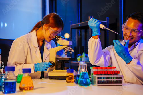 middle-aged man, an old woman, and a young woman collaborate in a lab at night, under blue and RGB lighting, researching food ingredients and conducting experiments with test tubes and microscopes. photo