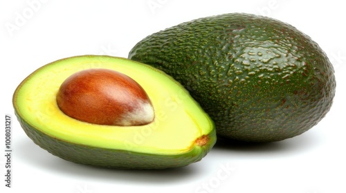 A perfectly ripe halved avocado with the seed exposed, displayed on a white background to emphasize its vibrant green flesh and smooth texture.