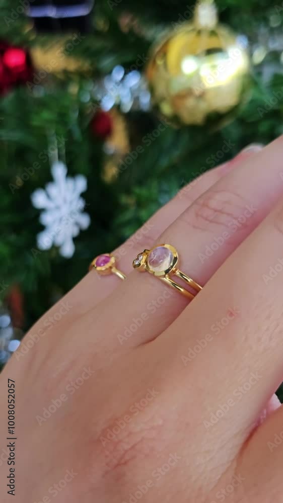 Ruby rings in gold setting on woman hand. Hand is moving to show sparkling of the diamond or gemstone as pink ruby with sunlight Ruby rings in gold setting on woman hand. Hand is moving to show sparkling of the diamond or gemstone as pink ruby with sunlight