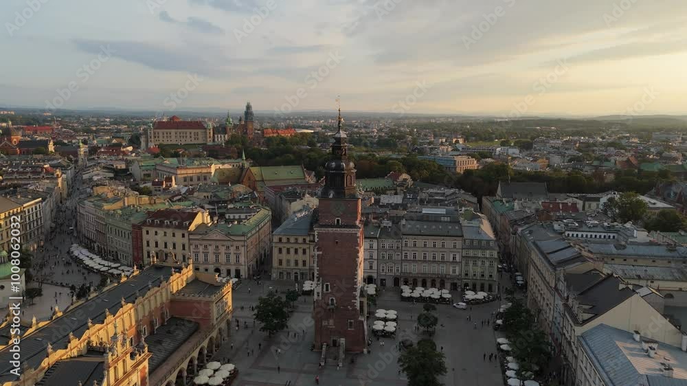 Aerial view of Town Hall Tower on Market Square in central historical tourist part of Krakow at sunset, Poland Aerial view of Town Hall Tower on Market Square in central historical tourist part of Krakow at sunset, Poland