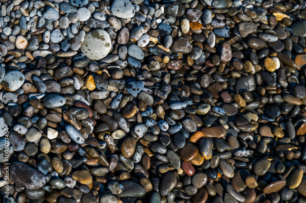 Wet sea pebbles close-up. Rocky beach on the sea, ocean, river, lake, pond. Natural background for design. Wet sea pebbles close-up. Rocky beach on the sea, ocean, river, lake, pond. Natural background for design.