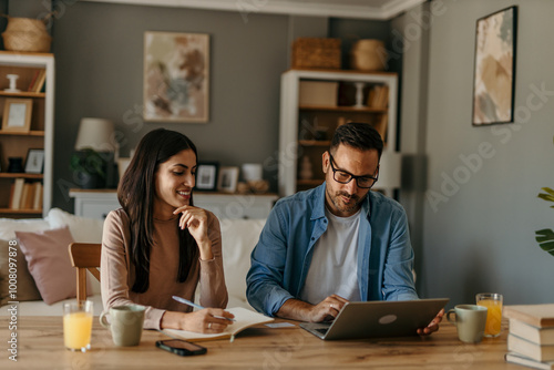 Adult caucasian couple girlfriend and boyfriend work from home and use laptop