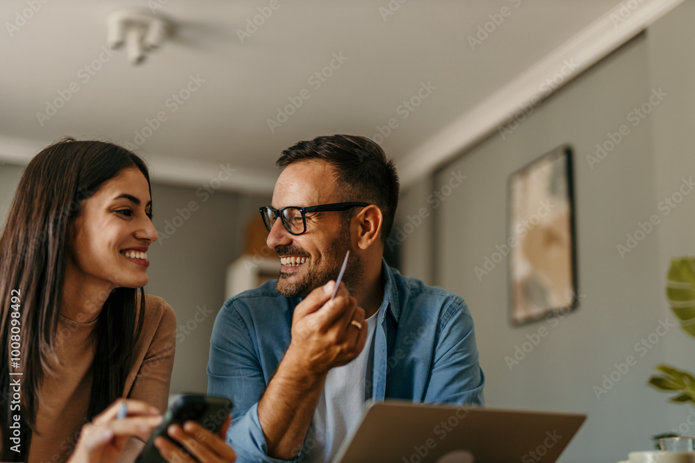 Adult couple buy online on laptop with credit card at home Adult couple buy online on laptop with credit card at home