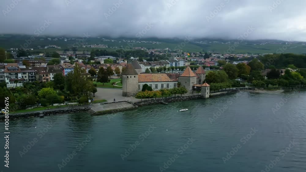 Low orbit drone shot of nice Rolle Castle with Lake Geneva in Vaud Switzerland Low orbit drone shot of nice Rolle Castle with Lake Geneva in Vaud Switzerland