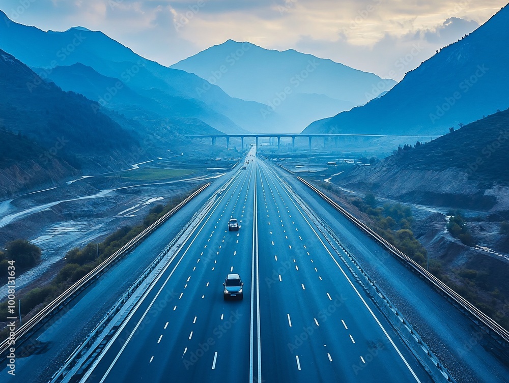 Aerial view of a highway stretching into the distance through a mountain pass. Aerial view of a highway stretching into the distance through a mountain pass.