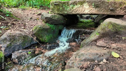 A small mountain river runs under the bridge
