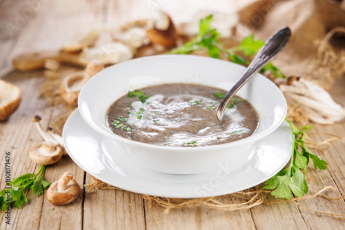 bowl of mushroom soup with cream and herbs