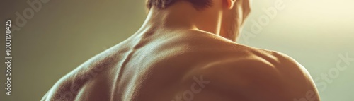 A close-up on a muscular back, showcasing strength and fitness in soft lighting, perfect for health and wellness themes.