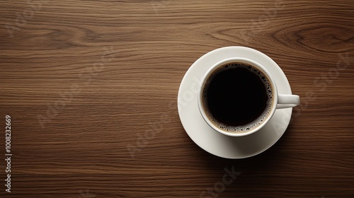 A cup of black coffee on a white saucer resting on a wooden table, inviting relaxation and contemplation.