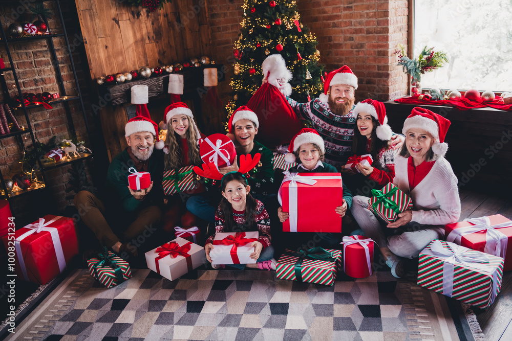 Full length portrait of big peaceful family sit floor hold presents festive christmas time together flat indoors Full length portrait of big peaceful family sit floor hold presents festive christmas time together flat indoors