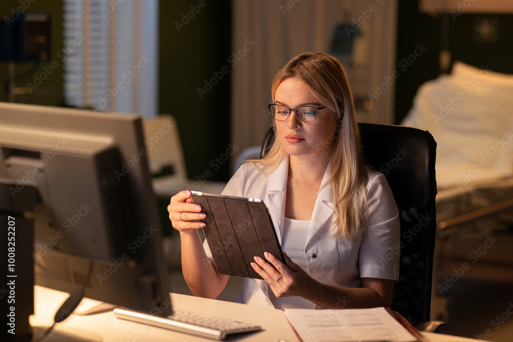 Using the computer and tablet, the doctor discusses recent test results with the patient, explaining findings. Using the computer and tablet, the doctor discusses recent test results with the patient, explaining findings.