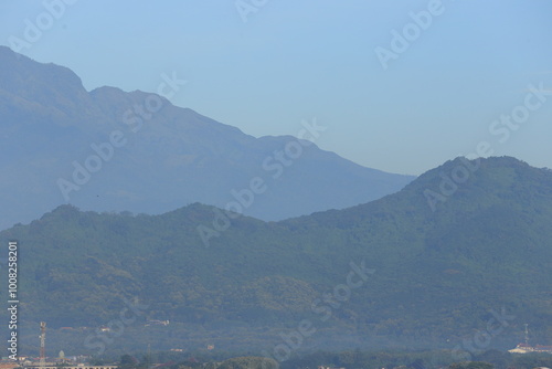 City Skyline with Skyscrapers and Mountain Range in the Background