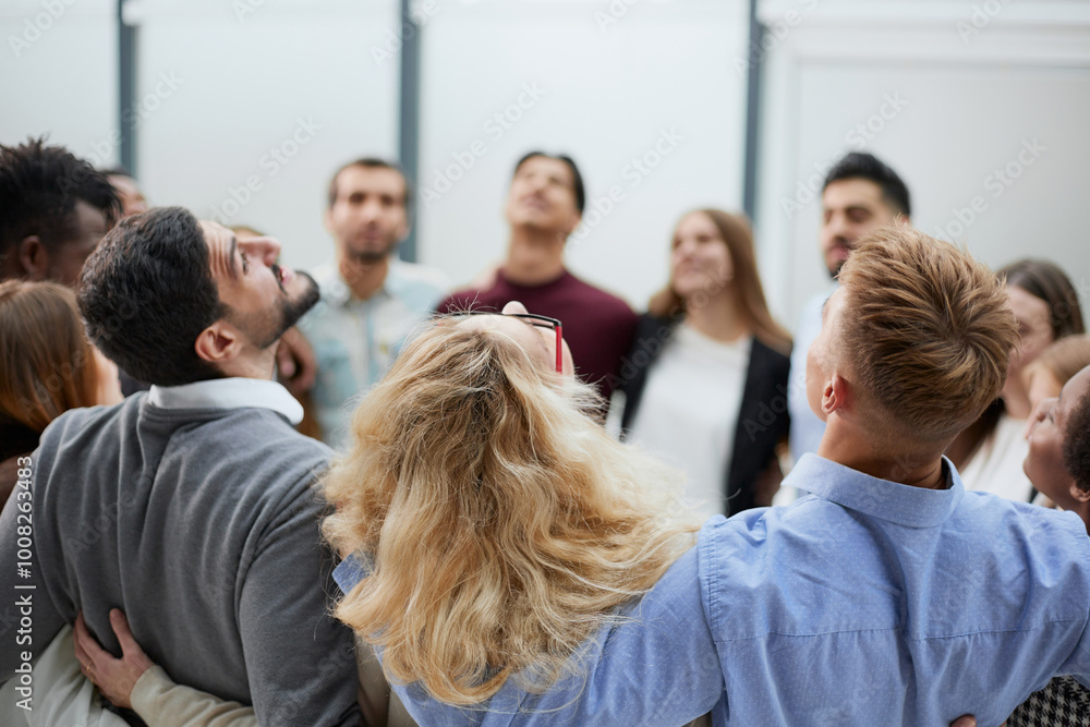 Team of young people hugging in the office. Team of young people hugging in the office.