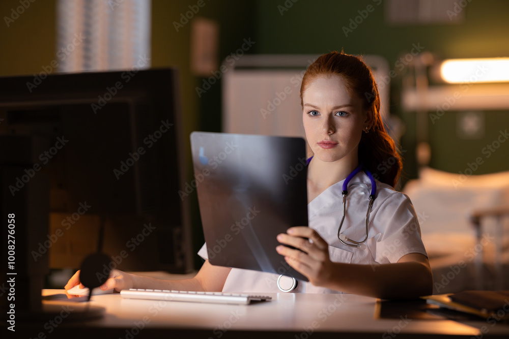 Doctor carefully analyzing X-ray scan. Doctor carefully analyzing X-ray scan.