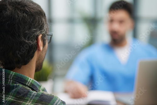 Doctor with patient in medical office at the reception