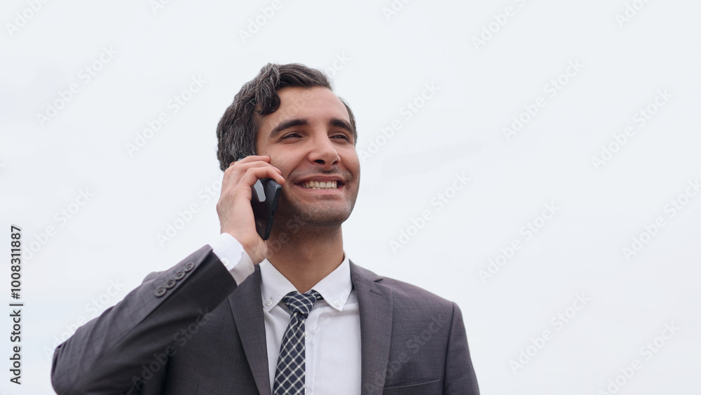 Young urban businessman professional on smartphone walking in street using app texting sms message on smartphone Young urban businessman professional on smartphone walking in street using app texting sms message on smartphone