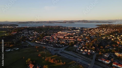 Aerial Drone Shot of a Busy Road Through a Suburban Neighborhood at Sunset in Stavanger, Norway photo