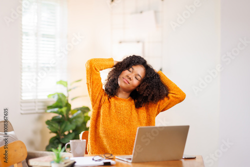 Portrait of sad upset woman feeling bad unwell with unhappy emotions holding hands on temples suffering from head ache sitting laptop desk. Health care concept 