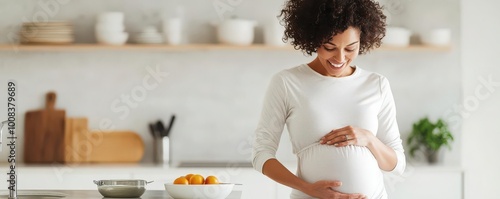 Pregnant woman in modern kitchen, joyful moment