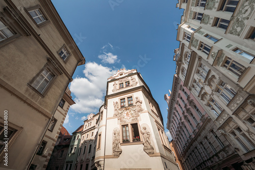 Narrow street with colorful historical buildings leading to hotel Prague