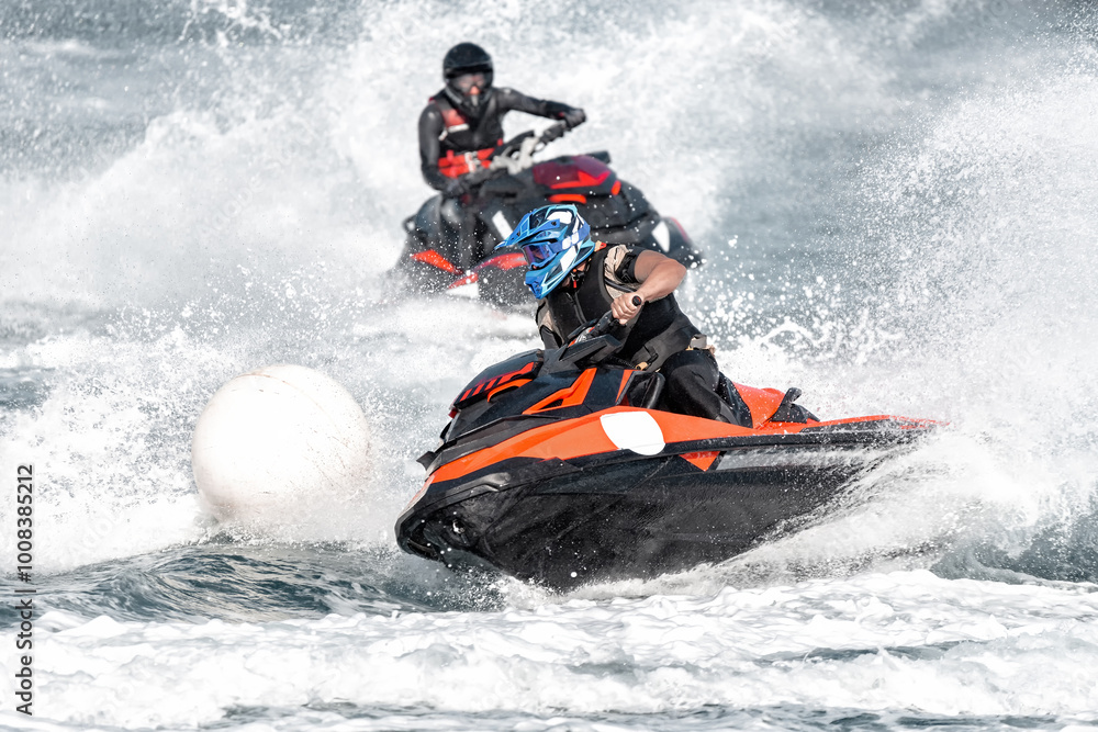 Professional jet ski racer turning around buoy at high speed during championship Professional jet ski racer turning around buoy at high speed during championship