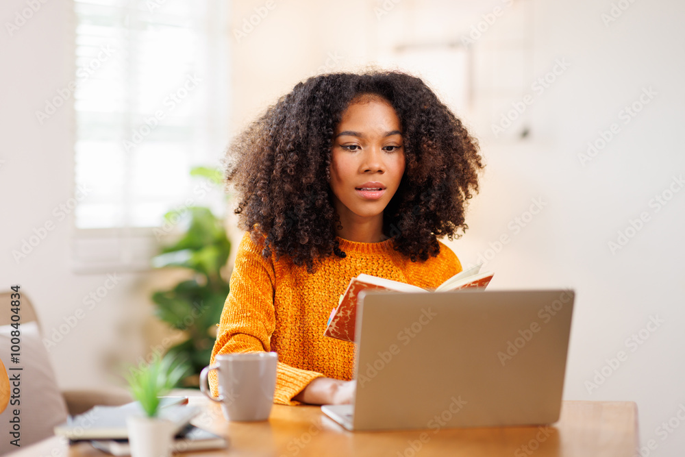 African American in Afro hair or girl using laptop computer learning distantly online sitting at desk at home. web education and E-learning
African American in Afro hair or girl using laptop computer learning distantly online sitting at desk at home. web education and E-learning