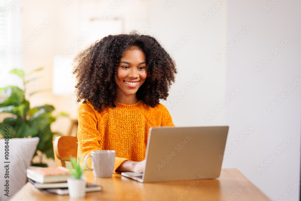 African American in Afro hair or girl using laptop computer learning distantly online sitting at desk at home. web education and E-learning
African American in Afro hair or girl using laptop computer learning distantly online sitting at desk at home. web education and E-learning