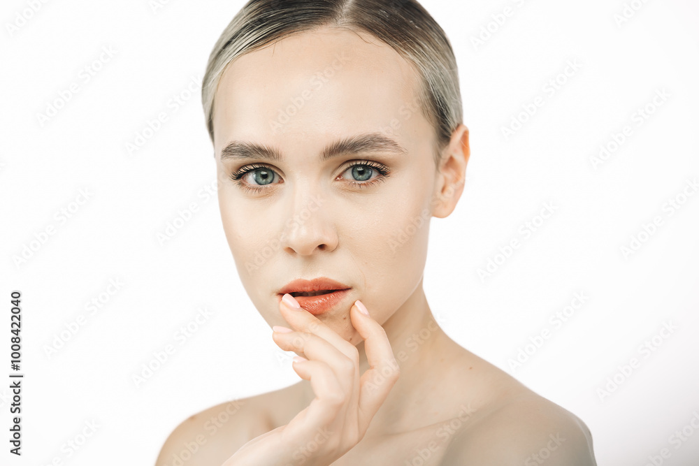 A beautiful model with flawless, fresh skin stands against a white background. This image highlights the significance of skincare and showcases a concept for cosmetic advertising. A beautiful model with flawless, fresh skin stands against a white background. This image highlights the significance of skincare and showcases a concept for cosmetic advertising.