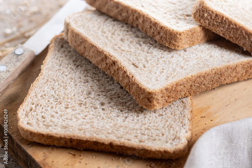 Healthy wholemeal bread slices on wooden table