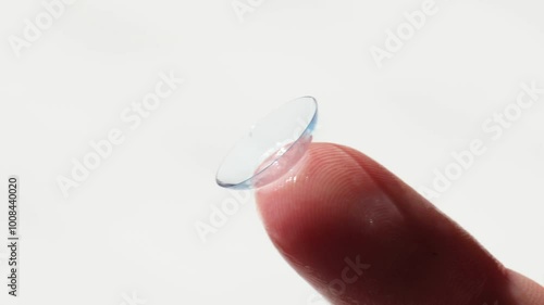 close-up, a contact lens on a woman’s finger for vision correction. the concept of correcting myopia and hyperopia.