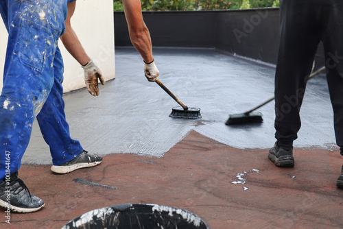 Two Workers Applying a Roof Waterproofing
